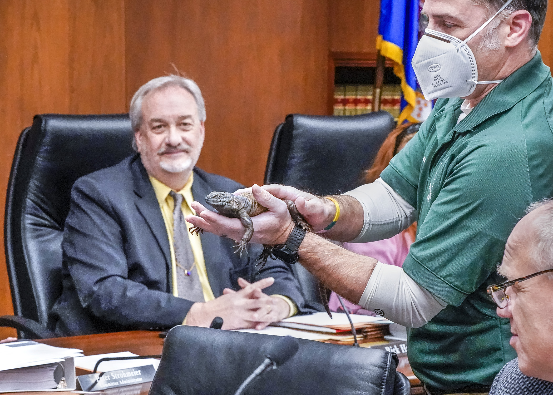 Naturalist Donnie Crook shows Rep. Rick Hansen and other members of the House Environment and Natural Resources Finance and Policy Committee a chuckwalla, a lizard native to the southwestern United States, Feb. 15. (Photo by Andrew VonBank)